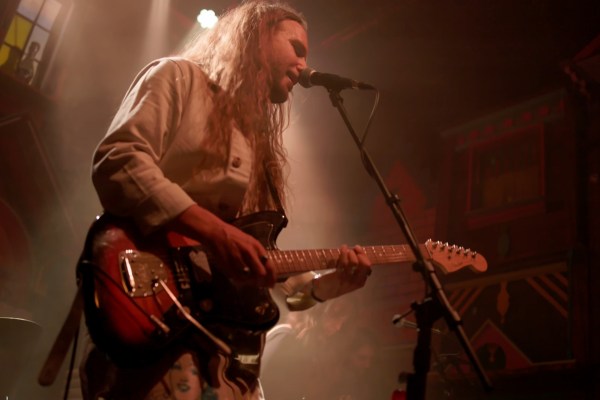 Zivi performing with his band at Meow Wolf